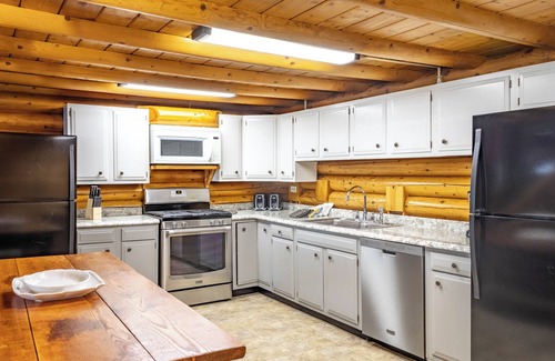 Walker Resort | Stunning Log Home on the water's edge with deck overlooking the swimming pool.