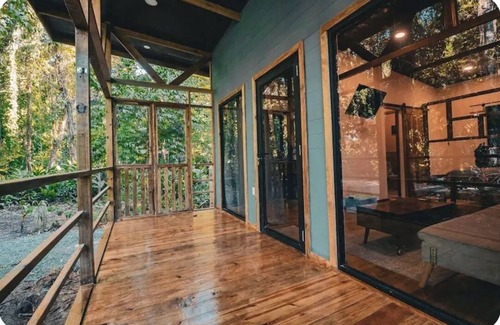 Bocas del Toro Cabin | Surfside tiny home with modern amenities like AC, modern design, bathtub,and TV.