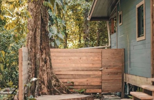 Bocas del Toro Cabin | Surfside tiny home with modern amenities like AC, modern design, bathtub,and TV.