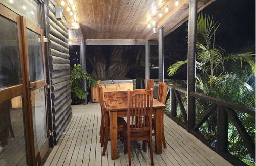 Whiritoa House | The Iconic Log Cabin By the Sea- Pets welcome! Spa! Pool Table/Ping Pong!