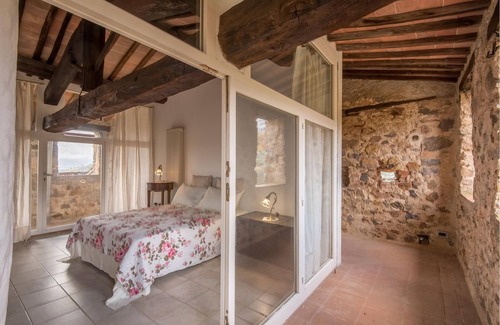 Stigliano Apartment | This apartment is located in a historic tower in the Castello del Poggiarello, a beautiful and chara