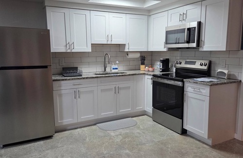 Port Richey House | This centrally located unit offers full kitchen and washer-dryer machine.