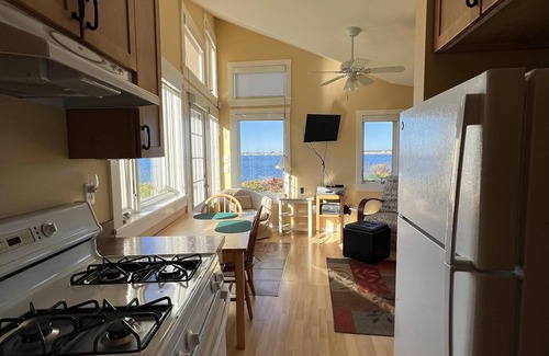 Mid-Coast and Islands Cottage | This sweet cottage offers a shared pebbly beachfront and gorgeous sunset views