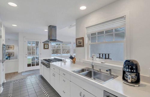 Water Mill House | Traditional-style home with private pool, sweeping back deck, grand lawn,.