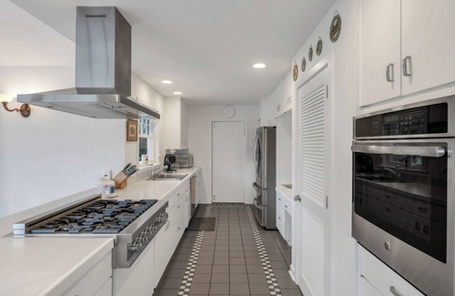 Water Mill House | Traditional-style home with private pool, sweeping back deck, grand lawn,.