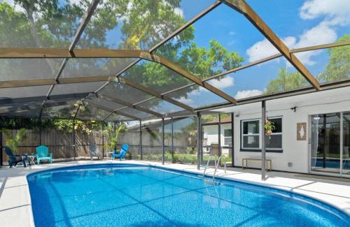 Hyde Park House | Tranquil Times a Serene 3BR Close to RJ Stadium with Screened Heated Pool, Outdoor Kitchen and Yard Chess