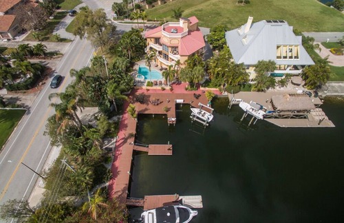 Gulf Harbors House | Tropical Waterfront Resort Home with Marina, Kayaks, Piano, Game Room