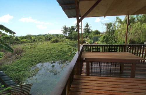 Ipoh House | Tung's Tropika - with a wooden hut by a lake