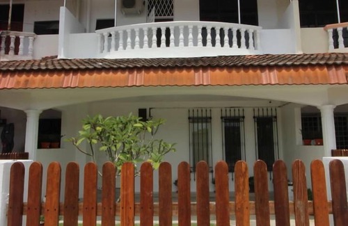 Ipoh House | Tung's Tropika - with a wooden hut by a lake