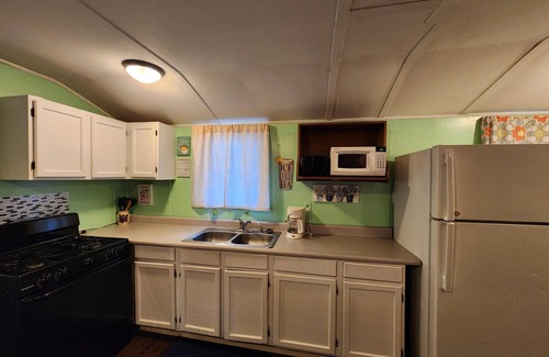 Monticello Cabin | Two Bedroom Cabin - Street & Pool View - Two bedroom cabin conveniently located at Outrigger Resort, right down the road from Indiana Beach Amusement Park! This 600 sq ft classic cabin offers two (2) queen beds and two (2) futons to sleep six (6)! Am