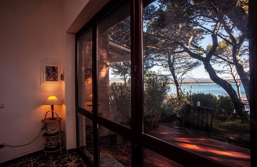 Porto Pino Villa | Vacation Home 'Fronte Mare Al Porticciolo' with Sea View, Barbecue Area & Wi-Fi