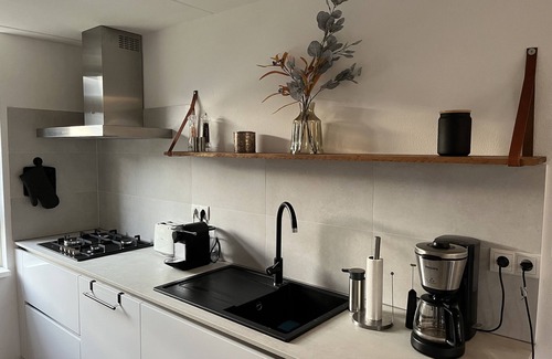 Medemblik House | Vacation home on the water with two private jetties and boat, W-Lan