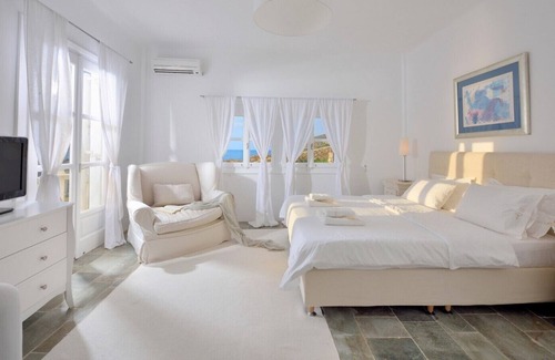 Ftelia Villa | Villa Juliet, beautiful beachfront villa in Mykonos with amazing sunset view by Elite Estates.