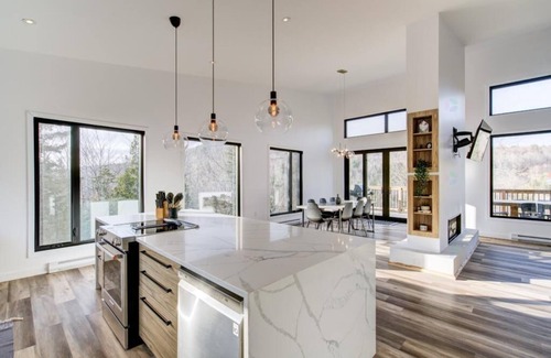 Sainte-Beatrix Ski Chalet | Vulcano Sauna and Spa, modern chalet with water access.