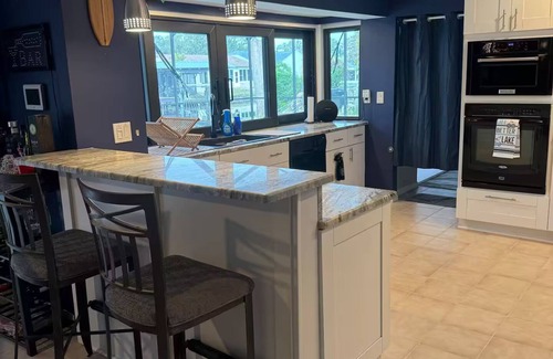 Palm Harbor House | Waterfront Lake Tarpon Home with heated salt water pool, fitness room, WiFi