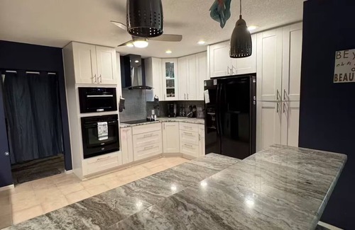 Palm Harbor House | Waterfront Lake Tarpon Home with heated salt water pool, fitness room, WiFi