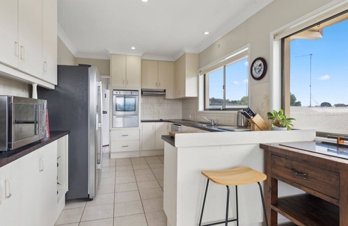 Sandy Beach House | You’ll love being front row on Sandy Beach in this airy elevated holiday home.