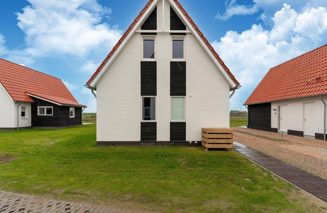 A modern holiday home by the sea with a sauna