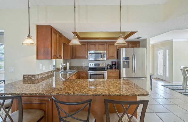 ABSOLUTELY GORGEOUS CANAL HOME WITH HEATED INGROUND POOL ON A QUIET STREET!