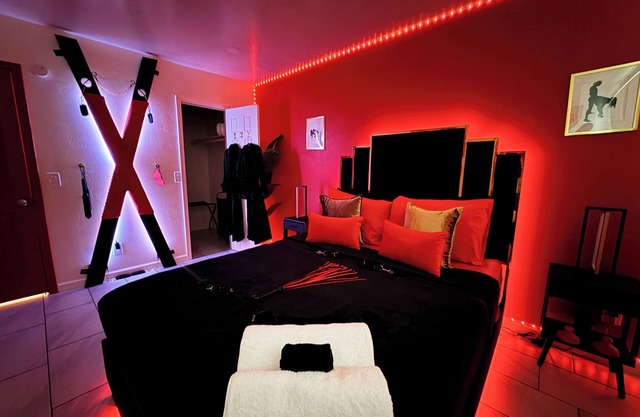 Adult-only fantasy suite with hot tub, dance pole, and kink-inspired furniture. Perfect for couples craving privacy, intimacy, and play. Discreet, clean, and unforgettable—your private Red Chamber escape.