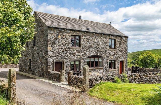 An 1800’s barn conversion with beams, exposed stonework and flagged floors.