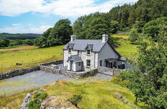 An impressive, detached stone-built cottage set within Gwydir Forest.
