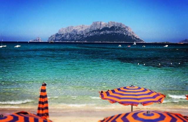 Beautiful bay of white sand and clear sea opposite the island Tavolara