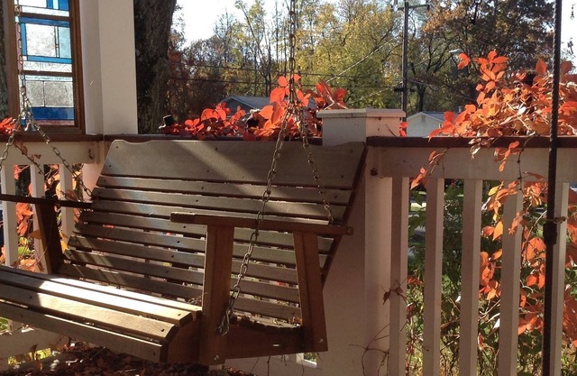 Beautiful home with shady front porch and rear sunroom in tree lined backyard.