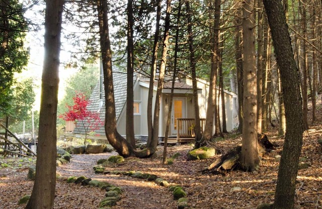 Charming updated A-frame home nestled in the woods adjacent to Kimberley Creek.