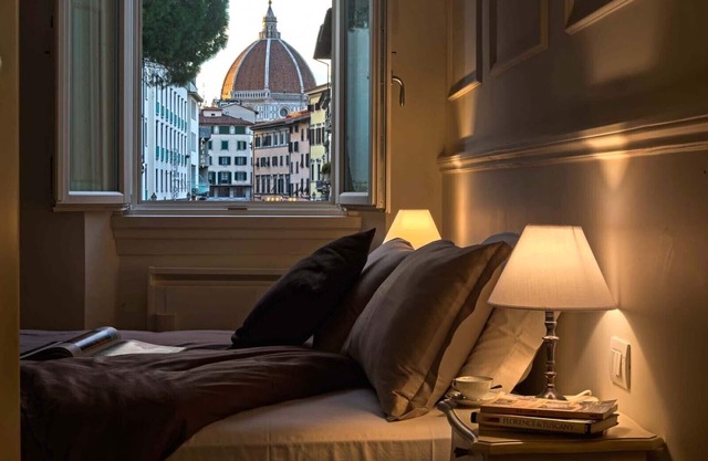 Deluxe suite with great view! Bed and view in the heart of Florence.
