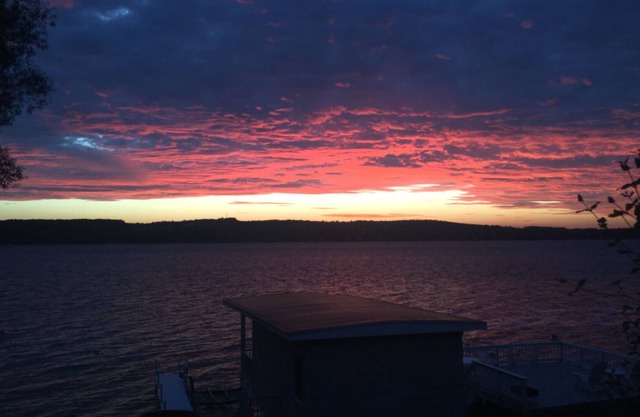 Enjoy east side sunsets in elegant, lakeside home with boathouse