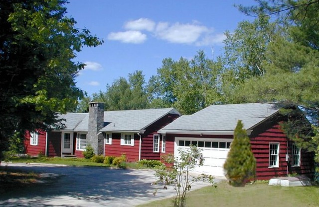Family compound on Thomas Pond featuring main house and two small cottages.
