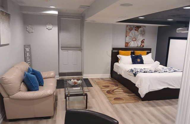 furnished basement studio, with1 queen bed, a kitchenette, and 1 bathroom. n