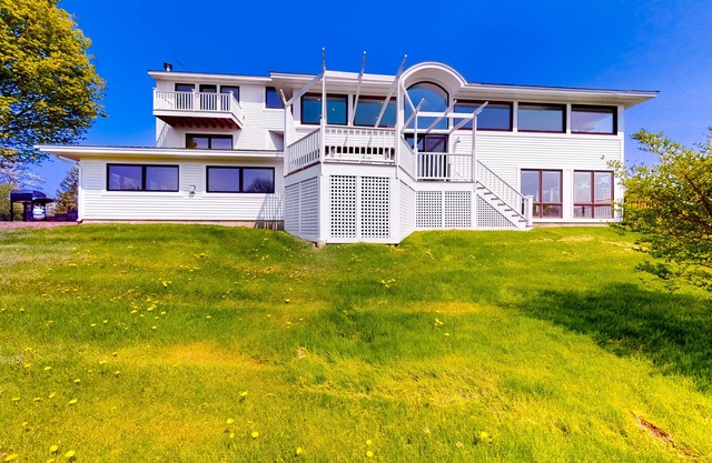 Gorgeous home with amazing lake views, fireplace, firepit, hot tub, & balcony