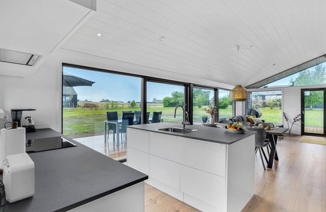 Here you can expect a modern vacation home with stylish interior and comfortable outdoor area.