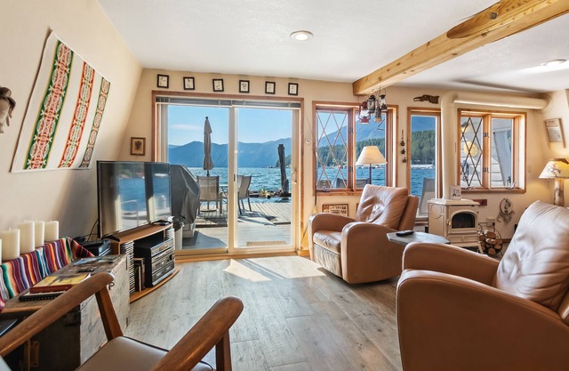 Incredible lakefront floating home with mountain views, balcony, & gas fireplace