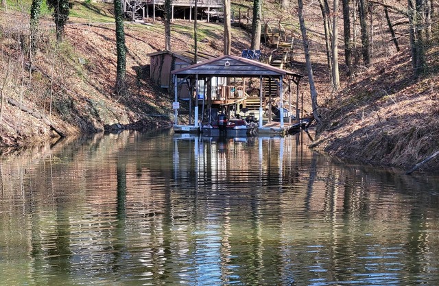 Lake Front. Large shaded deck with Covered Dock access. Fire pit.