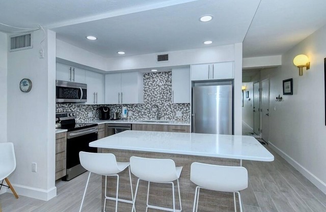 LaPlaya 101A - Step out to the beach from your screened lanai. Light and bright end unit.