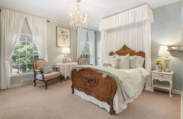 Magnolia suite with queen size bed, sitting area, soaking tub and smart tv
