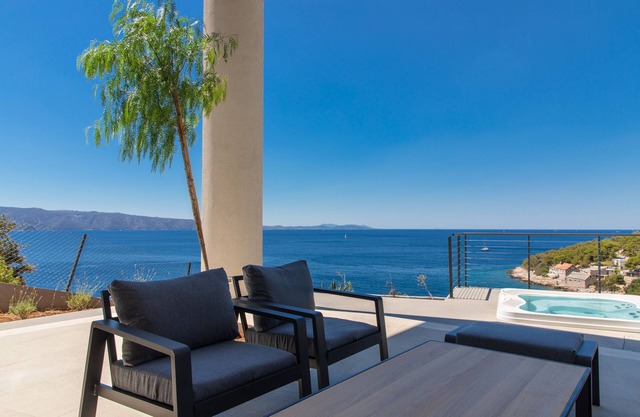 Modern beachfront villa in exceptional seculed bay with pool