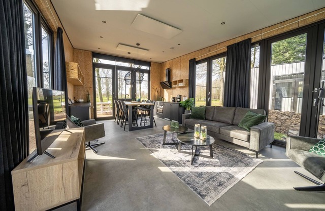 Modern chalet by the river Maas