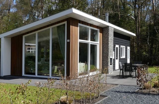 Modern chalet with a barbecue at the forest