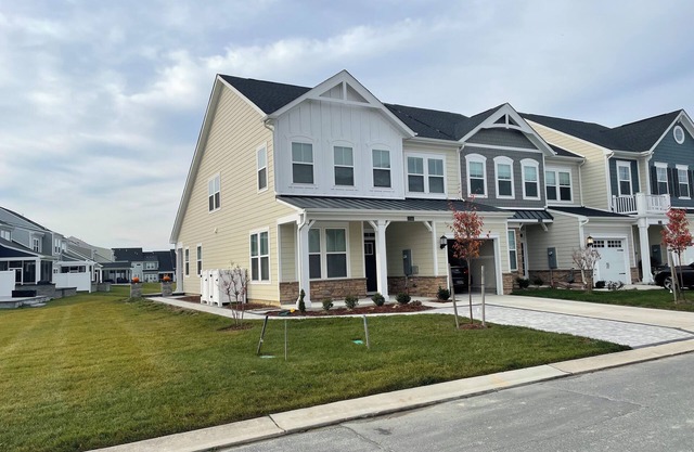 Newly built end unit townhouse with Pond views in The Peninsula!