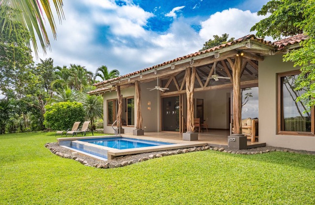 Ocean-view villa with private pool, furnished lanai, & lush, tropical setting