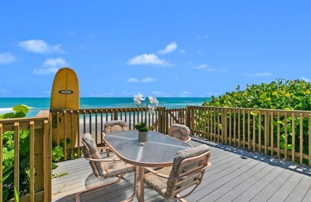 Oceanfront home with solar-heated pool facing the beachn