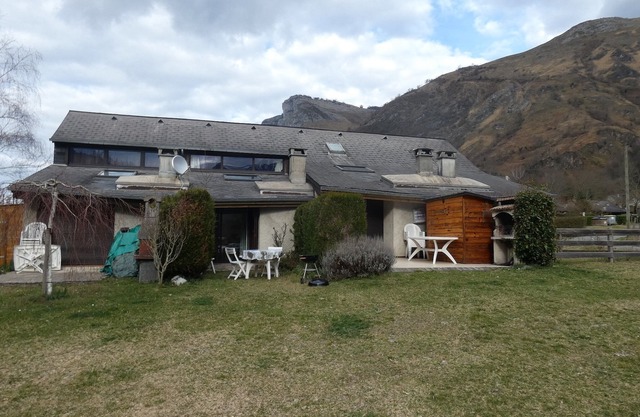 On river bank with mountain views and ground-level terrace