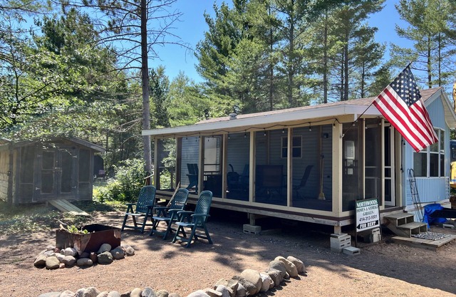 Parkmodel cabin w screened porch in campground on bike trail.