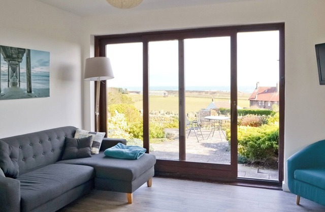 Part of a small terrace of bungalows with uninterrupted views towards the sea.