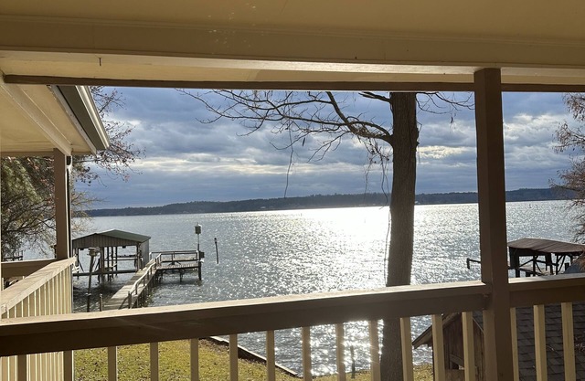 Peaceful lake front home with wrap around porch and relaxing views!