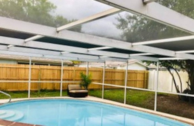 Pool house with 2 bedrooms , 2 baths and a backyard